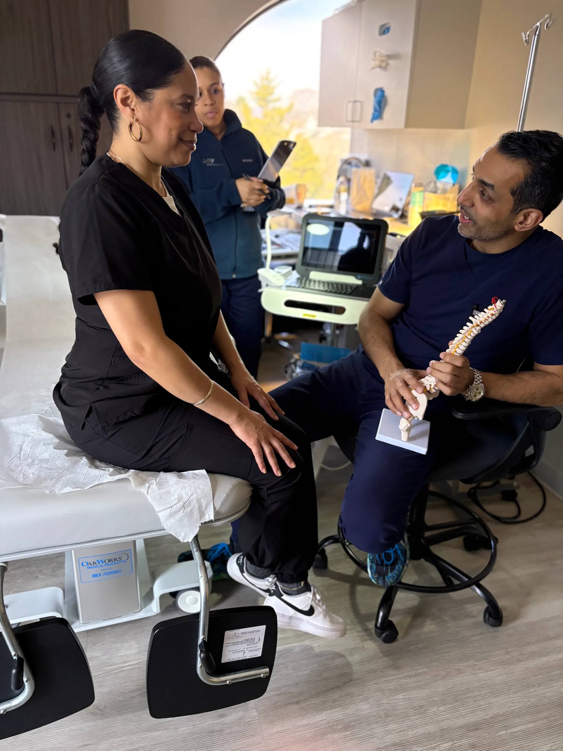 Doctor performing back pain diagnostic examination